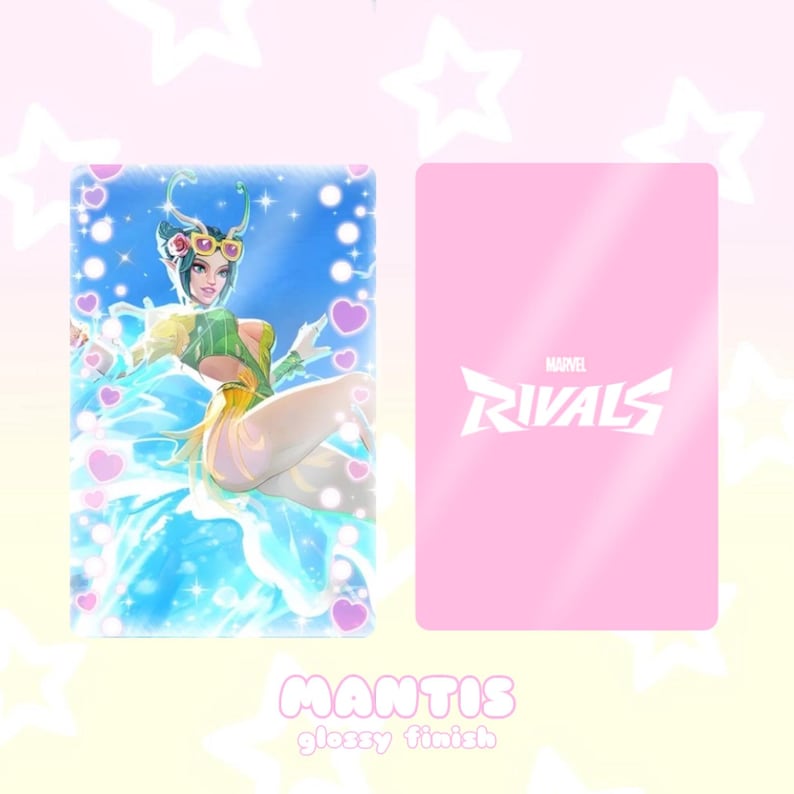 May include: A glossy trading card featuring Mantis from Marvel Rivals. The front of the card displays Mantis in a flowing blue and green outfit, surrounded by hearts and sparkles. The back of the card is pink with the Marvel Rivals logo.