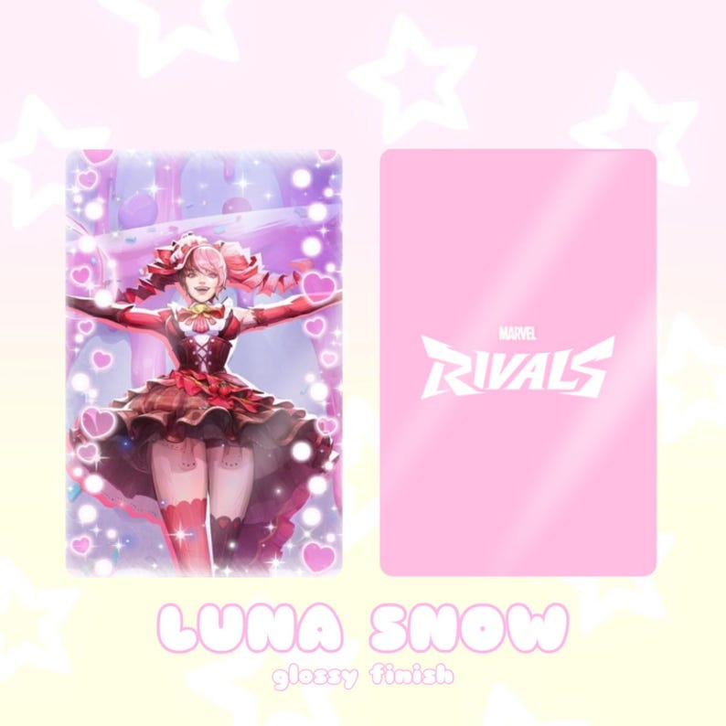 May include: A glossy card featuring Luna Snow from Marvel Rivals. The front displays a detailed illustration of the character in a red and brown dress, surrounded by hearts. The back is solid pink with the Marvel Rivals logo.