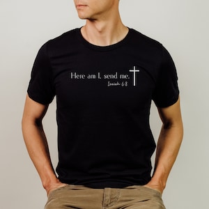 May include: A black t-shirt with white text that reads "Here am I, send me." and "Isaiah 6:8" with a white cross.