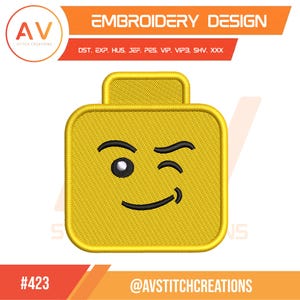 May include: Yellow embroidered design of a Lego-style head with a winking eye and a smile. The design includes the text "EMBROIDERY DESIGN" and the logo of "AV STITCH CREATIONS". The design is labeled with the number "#423".