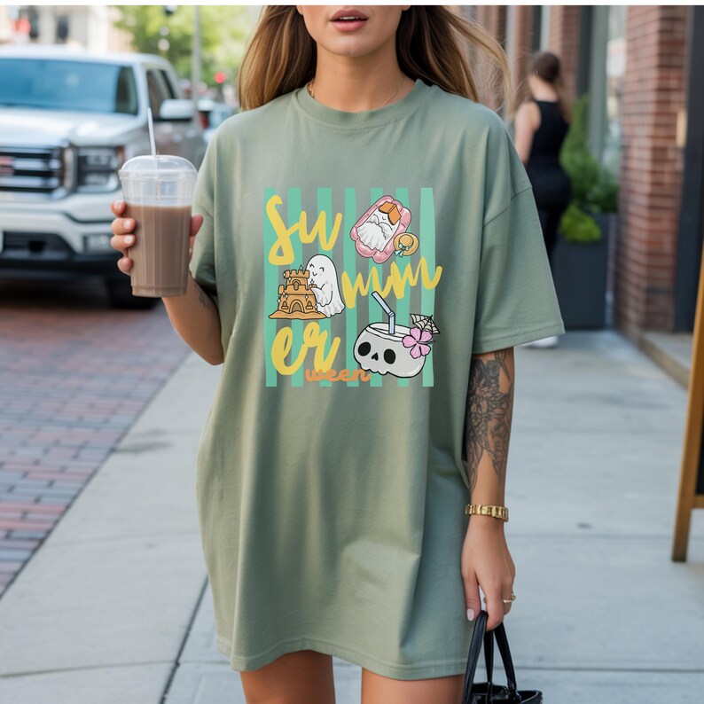 Cute Summerween ghost shirt design with striped background, ghost building sandcastle, ghost on float, skull coconut drink and tropical spooky summer aesthetic