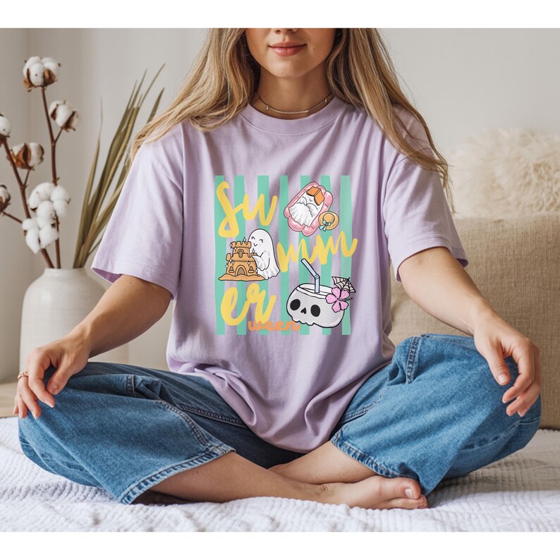 Cute Summerween ghost shirt design with striped background, ghost building sandcastle, ghost on float, skull coconut drink and tropical spooky summer aesthetic