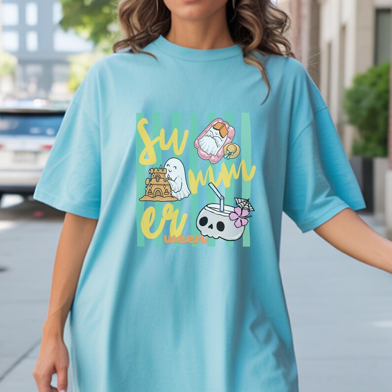 Cute Summerween ghost shirt design with striped background, ghost building sandcastle, ghost on float, skull coconut drink and tropical spooky summer aesthetic
