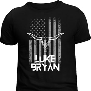 May include: Black t-shirt with a distressed American flag design featuring a white bull skull and the text "I LUKE BRYAN".