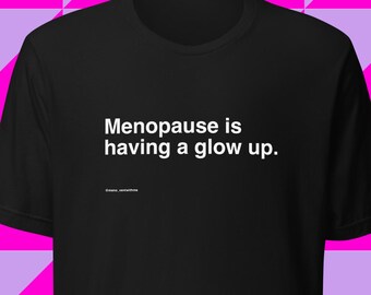 Menopause is having a glow up. Women's midlife humor t-shirt, black