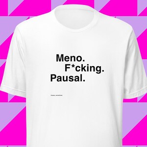 May include: White t-shirt with black text that reads "Meno. F*cking. Pausal."