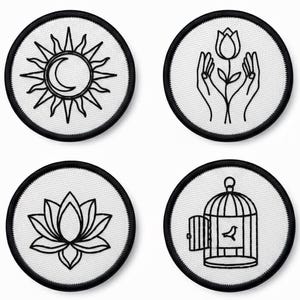 May include: Four circular patches featuring black and white designs. The designs include a sun and moon, hands cradling a flower, a lotus flower, and a bird in a cage. Each patch has a black border.