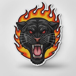 May include: Embroidered patch featuring a black panther with red eyes and an open mouth, surrounded by orange and yellow flames. The patch has a white border and is likely for clothing or accessories.