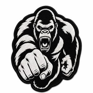 May include: A black and white embroidered patch featuring a forward-facing gorilla with an aggressive expression, baring its teeth. The gorilla is depicted in a dynamic pose with one fist extended toward the viewer, framed by a thick black border.