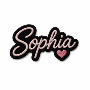 May include: An embroidered patch featuring the name Sophia in a light pink cursive script font. The lettering is outlined in a thick black border, and a small, solid light pink heart is positioned below the letter h to complete the design.