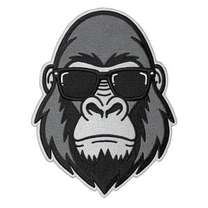 May include: Embroidered patch of a gorilla's head wearing black sunglasses. The gorilla is in shades of grey and black, with a white outline. The patch has a cool, relaxed vibe.