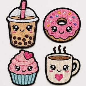 May include: Four embroidered patches featuring cute food items with faces: a tan bubble tea with a pink straw, a pink doughnut with colourful sprinkles, a pink cupcake with a heart, and a cream-coloured coffee mug with a pink heart design.
