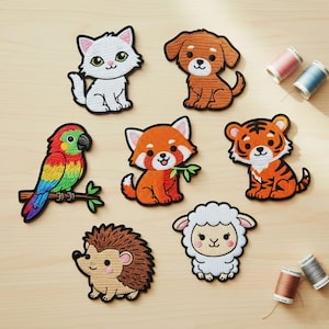 May include: A collection of embroidered animal patches, including a white cat, brown dog, colorful parrot, red panda, tiger, hedgehog, and lamb. Each patch features detailed stitching and a black border. Sewing thread spools are visible in the background.