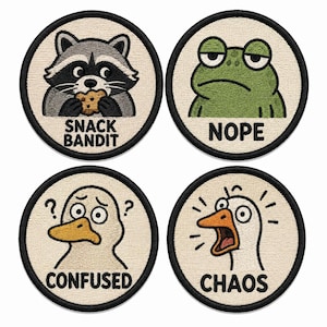 May include: Four circular embroidered patches with black borders on a cream background. The top left shows a raccoon eating a cookie with the text SNACK BANDIT. The top right shows a green frog with the text NOPE. The bottom left shows a confused duck with the text CONFUSED. The bottom right shows a screaming goose with the text CHAOS.