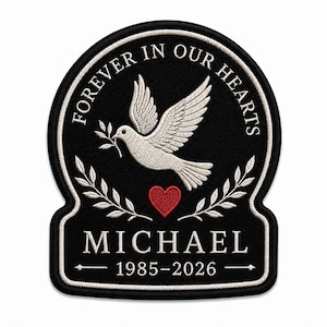 May include: A black embroidered patch featuring a white dove holding an olive branch, a red heart, and two laurel branches. The text reads FOREVER IN OUR HEARTS, MICHAEL, and 1985-2026 in white lettering with a white border on a black background.