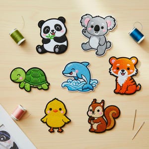 May include: A collection of embroidered patches featuring various animals, including a panda, koala, turtle, dolphin, tiger, chick, and squirrel. Each patch has vibrant colors and detailed stitching, perfect for decorating clothing or accessories.