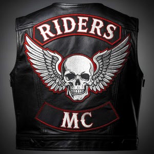 May include: Black leather vest featuring a large embroidered skull with wings, the word "RIDERS" arched above, and "MC" below. The embroidery is white and red, creating a striking contrast against the black leather. A classic biker style.