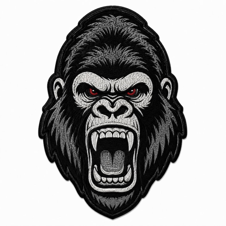 May include: An embroidered patch featuring the head of a gorilla with black and grey fur. The gorilla has a wide-open mouth showing teeth and gums, and piercing red eyes. The design is outlined in black thread with a detailed stitched texture.