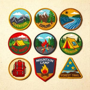May include: A collection of embroidered patches with outdoor adventure themes. Designs include mountains, rivers, tents, campfires, and a backpack. Text includes "Adventure", "Explore", "Wild North", "Mountain Camp", and "Forest Trail". The patches are round and triangular.