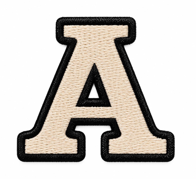 May include: A varsity-style letter A patch featuring a cream-colored center with a thick, black embroidered border. The letter has a classic block font design with a textured, stitched finish throughout the entire surface of the patch.