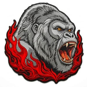 May include: A circular embroidered patch featuring a detailed illustration of a snarling silverback gorilla with bared teeth and orange eyes. The gorilla is surrounded by stylized, vibrant red flames that frame the lower and side edges of the design.
