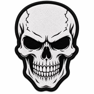 May include: An embroidered patch featuring a white human skull with deep black eye sockets and a black nasal cavity. The skull has visible crack lines on the forehead and a set of clenched teeth, all outlined with a thick black border.