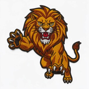 Puede incluir: Un parche bordado que muestra un león rugiendo con melena de color marrón dorado, pelaje naranja y contornos negros. El león aparece en una pose dinámica de salto con las patas delanteras extendidas, mostrando garras blancas y boca abierta.