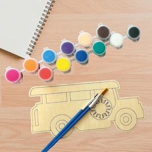 May include: A craft kit with a wooden car outline, paint pots in various colors, two paintbrushes, and a spiral-bound notepad. The paint pots include pink, orange, red, yellow, blue, purple, beige, brown, white, and black.