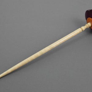 Carved flower supported spindle