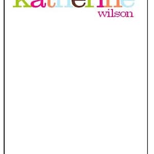 May include: A white notepad with the name "katherine wilson" written in colorful letters at the top.