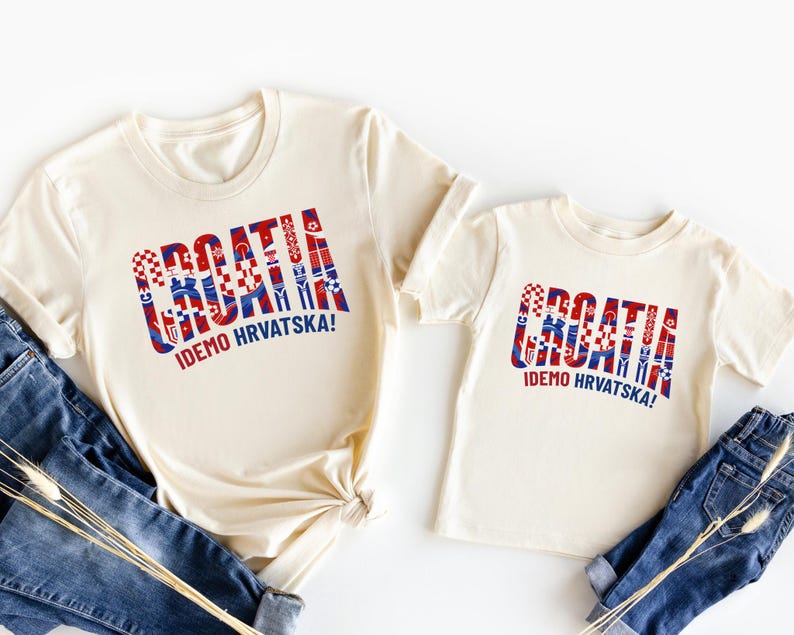 two white t-shirts with the word "Croatia" printed on them, along with a smaller child's t-shirt. The t-shirts are laid out on a white background, and there are also some jeans visible in the image.