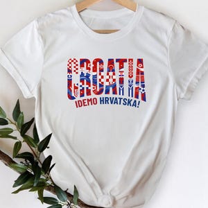A white t-shirt with the text "Croatia" and "IDEO HRVATSKA!" printed on it, along with a graphic design that appears to be the national flag of Croatia.