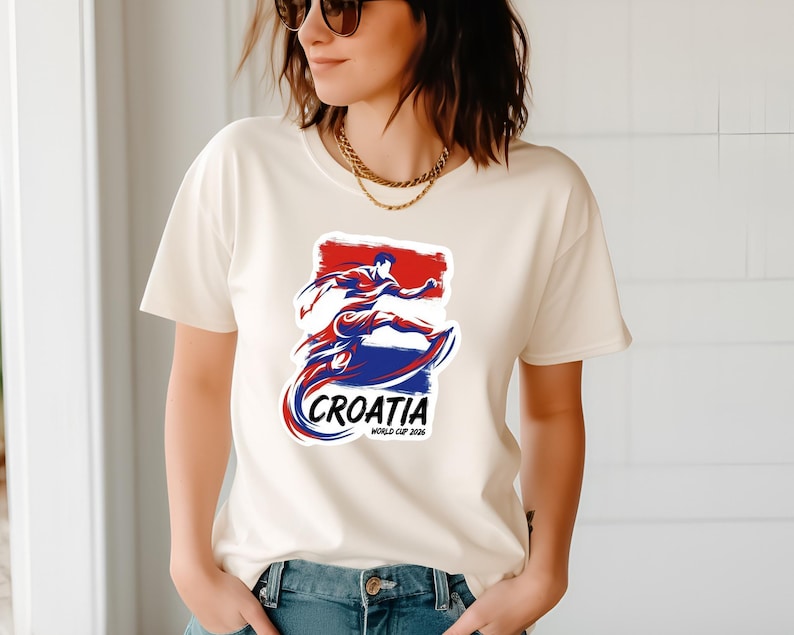 A woman wearing a white t-shirt with a graphic design of a person in a fighting stance and the text "CROATIA" printed on it.