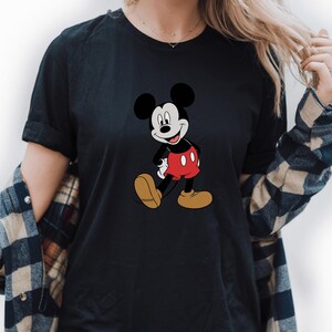A woman wearing a black t-shirt with a Mickey Mouse graphic printed on it.