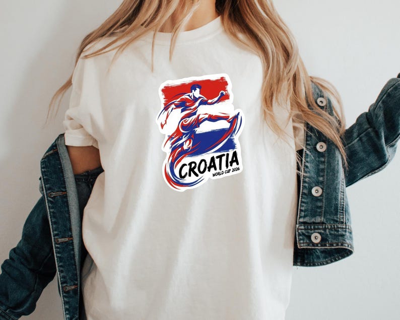 A person wearing a white t-shirt with a graphic design of a person in a fighting stance and the text "Croatia" printed on it.