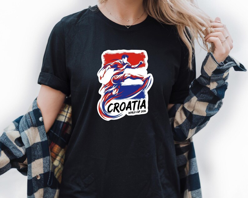 A person wearing a black t-shirt with a graphic design featuring a figure in a red, white, and blue color scheme, along with the text "Croatia" and "WORLD CUP".