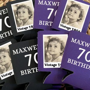 May include: A collection of black and purple can coolers. Each cooler features a vintage black and white photo of a child. Text includes "MAXWELL 70 BIRTHDAY" and "Vintage 1956".