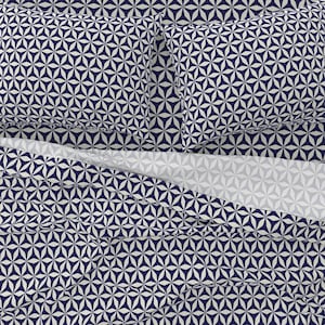 May include: A navy blue and white geometric patterned bedding set with a flat sheet, fitted sheet, and two pillowcases.
