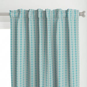 May include: A teal and white patterned curtain with a geometric design. The curtain is made of a lightweight fabric and has a subtle sheen.