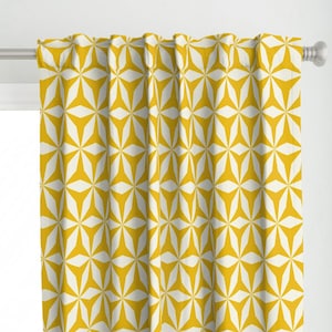 May include: Yellow curtains with a white geometric pattern. The pattern is made up of repeating star shapes.