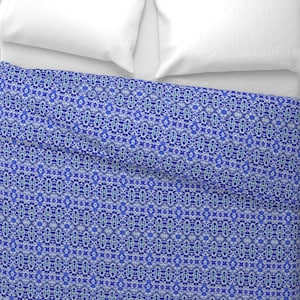 May include: A blue and white patterned duvet cover with a geometric design. The duvet cover is made of a soft, comfortable fabric and is perfect for adding a touch of style to any bedroom.