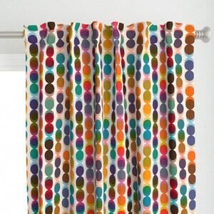 May include: A pair of white curtains with a colorful pattern of overlapping circles in shades of red, orange, yellow, green, blue, purple, brown, and pink.