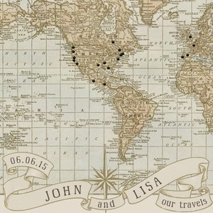 May include: A vintage world map with black dots marking locations, a compass rose, and a banner with the text "John and Lisa our travels" and the date "06.06.15".