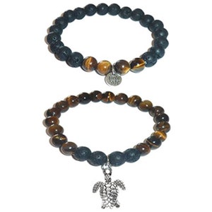 May include: Two bracelets with tiger's eye and lava rock beads. One bracelet has a silver charm with a lotus flower design. The other bracelet has a silver turtle charm.