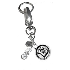 May include: Silver keychain with a letter E charm, a crystal bead, and a small silver charm with the word "You" on it.