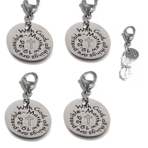 May include: Silver-toned charms with lobster clasps. Four charms feature a circular pendant with the text "With God all things are possible - Matthew 19:26" and a cross. One charm has clear beads and a lotus flower charm.