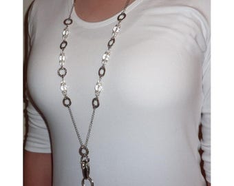 May include: A silver-toned lanyard featuring a chain design interspersed with clear, faceted, round beads and textured silver rings. The lanyard terminates in a metal swivel clasp and a circular ring, providing a functional accessory.