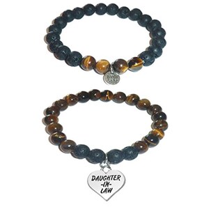 May include: Two beaded bracelets. The top bracelet features black porous beads and brown tiger eye beads with a silver lotus charm. The bottom bracelet consists of brown tiger eye beads and black porous beads with a silver heart charm reading DAUGHTER-IN-LAW.