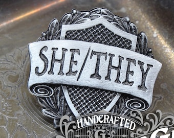 She/They Pronoun Badge - Pride Pronoun Pin - Handcrafted Pewter Accessories by Doctor Gus - Wearable LGBTQ Pride Enamel Pin LGBT Ally Badge