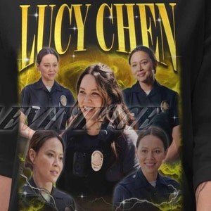 May include: Black t-shirt with a graphic print of Lucy Chen from the TV show "The Rookie". The graphic features a collage of images of Lucy Chen in her police uniform.